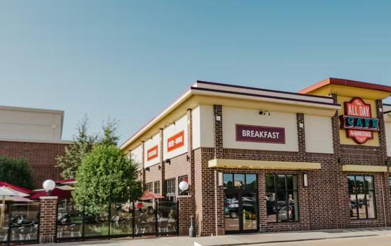 Exterior of All Day Cafe in a brick building with a Breakfast sign in Sioux Falls