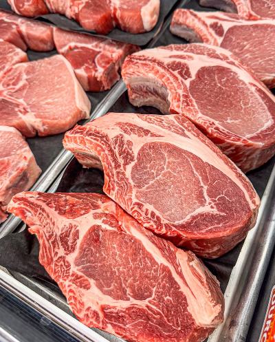 Raw steaks and cuts of beef laid out on a tray at Look's Marketplace