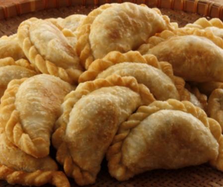 A pile of golden baked empanadas at Tarquin Argentinian Restaurant