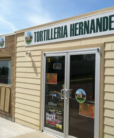 Storefront of Tortilleria Hernandez in Sioux Falls with glass doors and a green sign