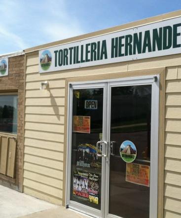 Storefront of Tortilleria Hernandez in Sioux Falls with glass doors and a green sign