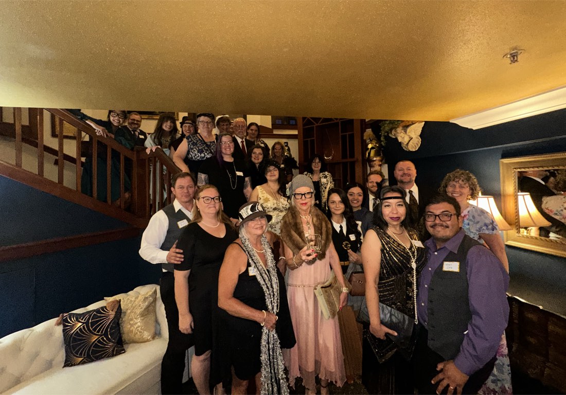 A large group of guests in 1920s-style costume gathered on a staircase at The Quinn Estate